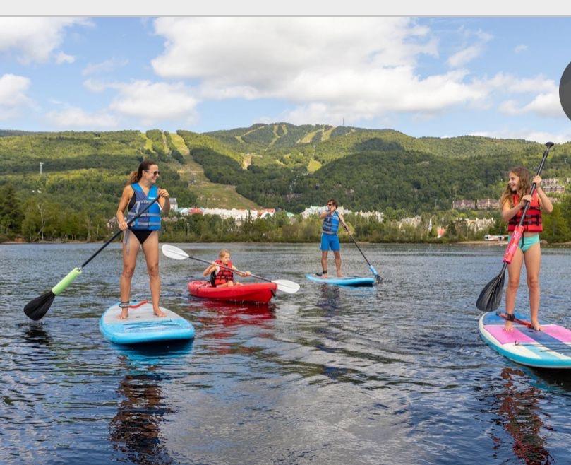 people using stand up paddle boards in Tremblant Canada